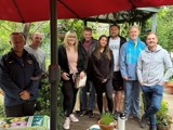 A group of volunteers standing under a parasol at Lovaine Community Garden